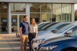 Couple shopping for a car at dealership with bad credit looking at sedan options