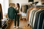 Person shopping for affordable quality clothes on a budget in a retail store