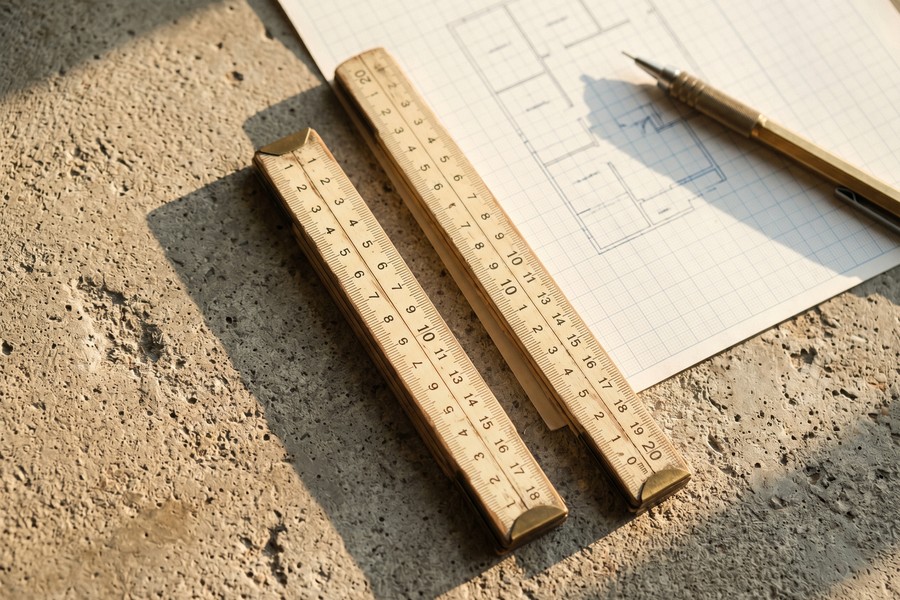 Homeowner reviewing tax documents and Schedule A at a home desk with a calculator and laptop