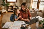 Self-employed parent reviewing child-related tax breaks and deductions at a home office desk